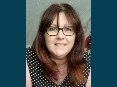Bridget, Peaches supporter, white female, long brown hair, wearing glasses, black and white dot top
