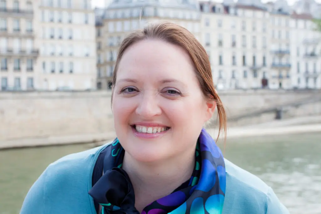 Debby, Peaches supporter, white female, brown hair tied back, wearing blue top and dotty scarf
